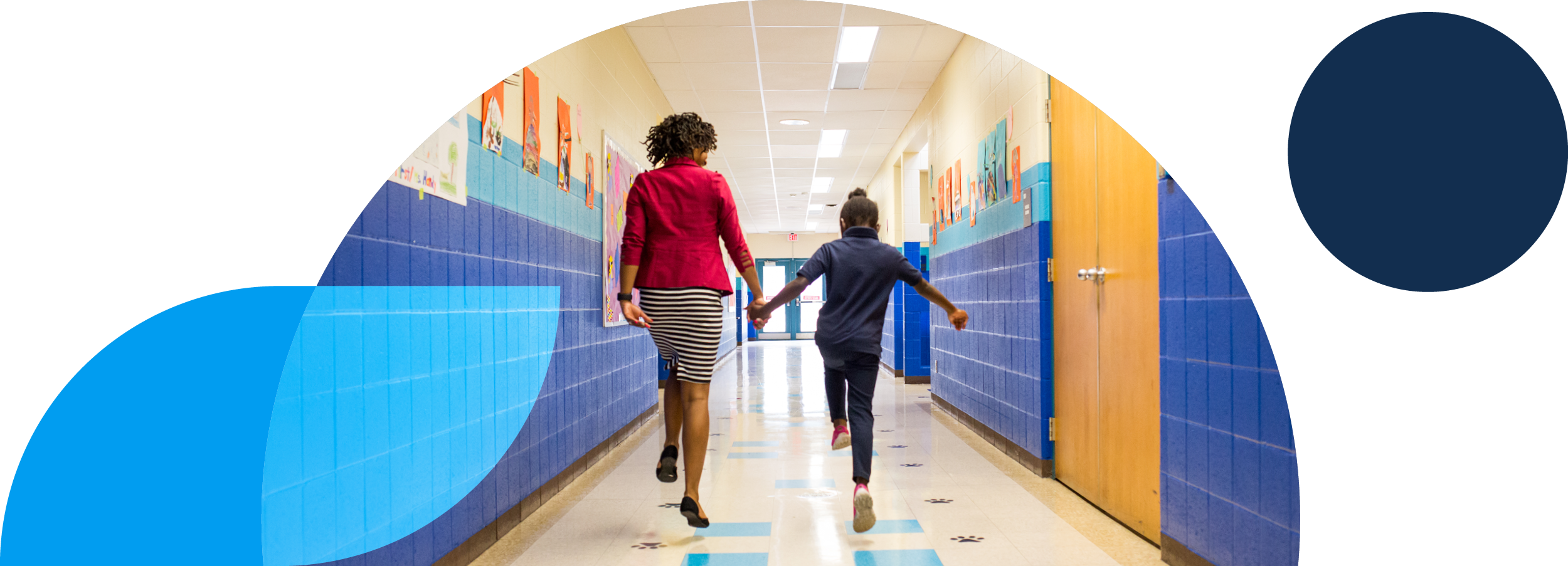 IUE website imagery — student and teacher skipping through hallway